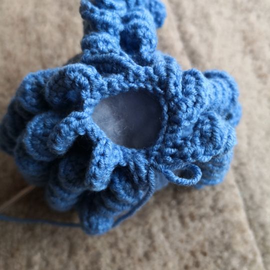 Bottom view of the blue crocheted octopus.