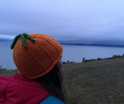 Girl wearing crochet pumpkin hat with Lake Balaton in the background.