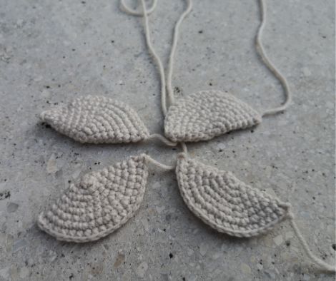 Four legs of the crochet sunflower turtle displayed.